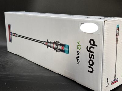 boxed box of a vacuum cleaner on a table with a black background