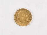 an old gold coin on a white surface with a white background