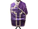 a purple and white robe on a stand with a hat on top