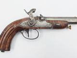 an old gun with a wooden handle on a white surface