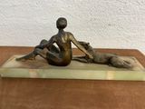 bronze sculpture of a woman and a dog on a marble base