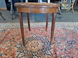 a small table with a basket on top of it