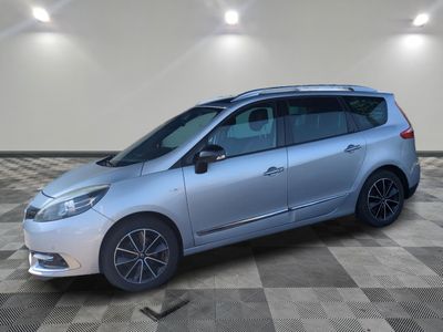a silver car is parked in a room with a checkered floor