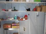 a room with shelves and boxes on the wall