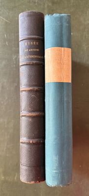 two old books sitting on a table next to each other