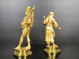 pair of antique brass figurines of a man and a woman