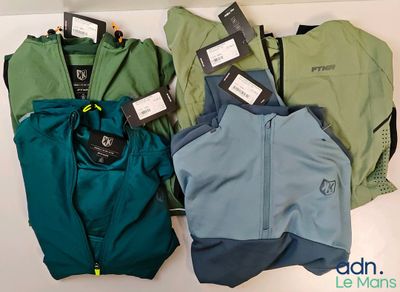 three pairs of men ' s running jackets with tags on them