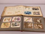 an open book with pictures of people and animals on it