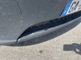 a close up of a car ' s front bumper with a number plate on it