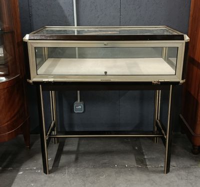 an image of a glass display case sitting on top of a wooden table
