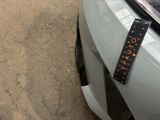a measuring tape on the front of a car ' s bumper