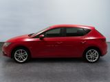 the red car is parked on the concrete floor in the room