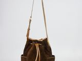 brown sued bucket bag on white background