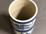 a blue and white cup sitting on a table