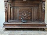 a wooden bench that has a duck on top of it