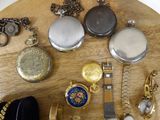 a wooden table topped with many different types of watches