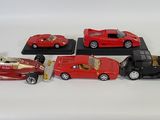 several toy cars are lined up in a row on a white surface