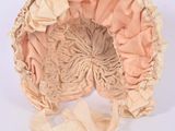 an image of a pink bonnet with a ribbon around it