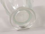 a glass jar with a lid on a white surface