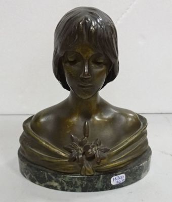 bronze bust of a woman with a flower in her hair