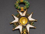 a close up of a medal with a red ribbon around it