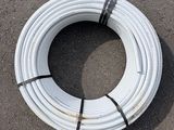a close up of a white pipe laying on the ground