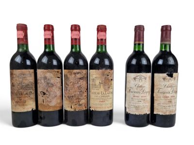 six bottles of wine are lined up on a white surface