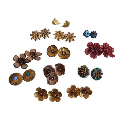 a close up of many different types of earrings on a white surface