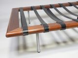 an image of a wooden bench with black straps