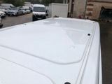a white van parked in a parking lot next to a building