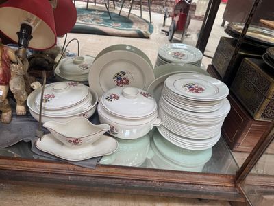 many plates and bowls on display in a glass case