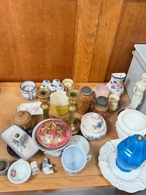 a wooden table with a lot of dishes and cups on it