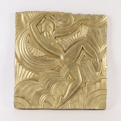 sculpture of a woman in a gold dress on a white background