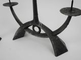a black candle holder with two candles on it