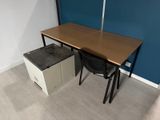 a desk and chair in a room with a blue wall