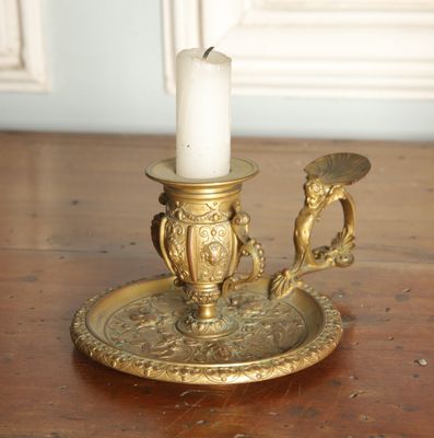 a candle that is sitting on a plate on a table