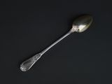 a spoon that is sitting on a black surface