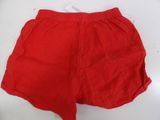 a pair of red shorts sitting on top of a white table