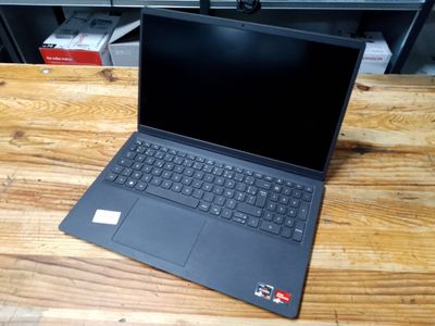 a laptop that is sitting on a wooden table