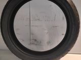 a close up of a tire on a white surface with a white wall in the background