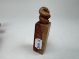 two small wooden figurines that are sitting on a table