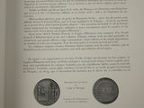 an open book with a picture of a coin and a coin on it