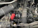 the engine of a car with its hood open and the hood down