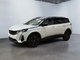 a white suv is parked in a large room with a white wall