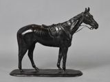 bronze statue of a horse with a saddle on a black base