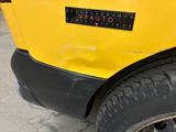 a close up of a yellow school bus with a sticker on it