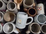 a lot of coffee mugs in a black container
