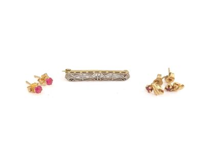three pairs of earrings and a ring on a white surface