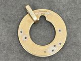 a brass plate with a hole in the middle of it