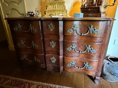 a dresser that has a clock on top of it